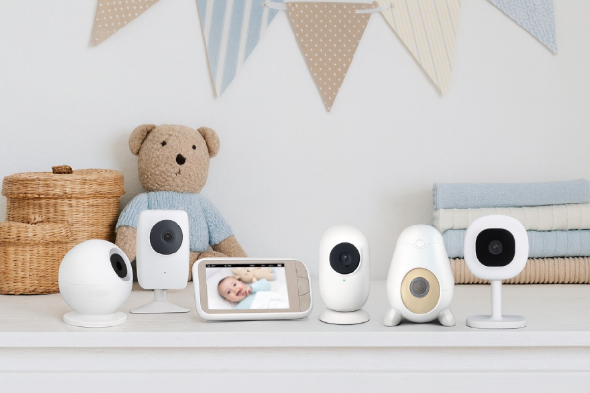 six of the best baby monitors arranged on a nursery dresser