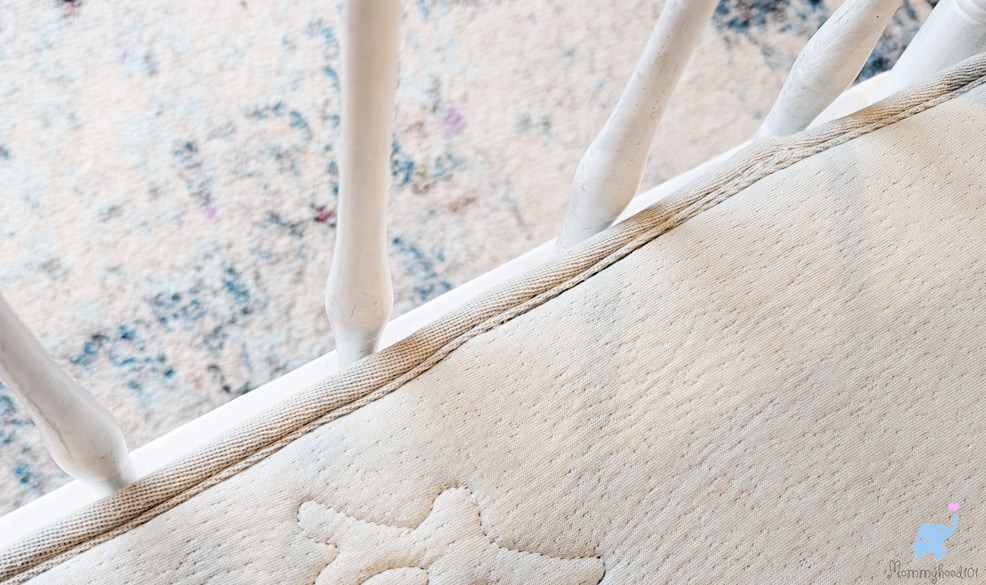 testing the fit of the katu crib mattress in a crib