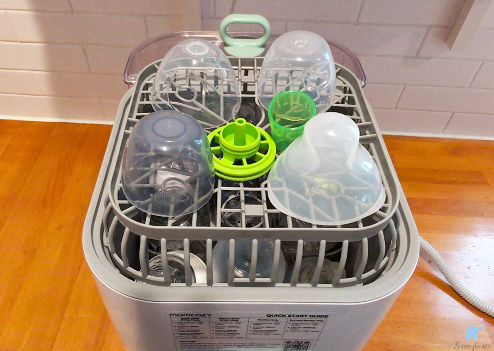 baby bottle lids on the upper rack of the momcozy bottle washer