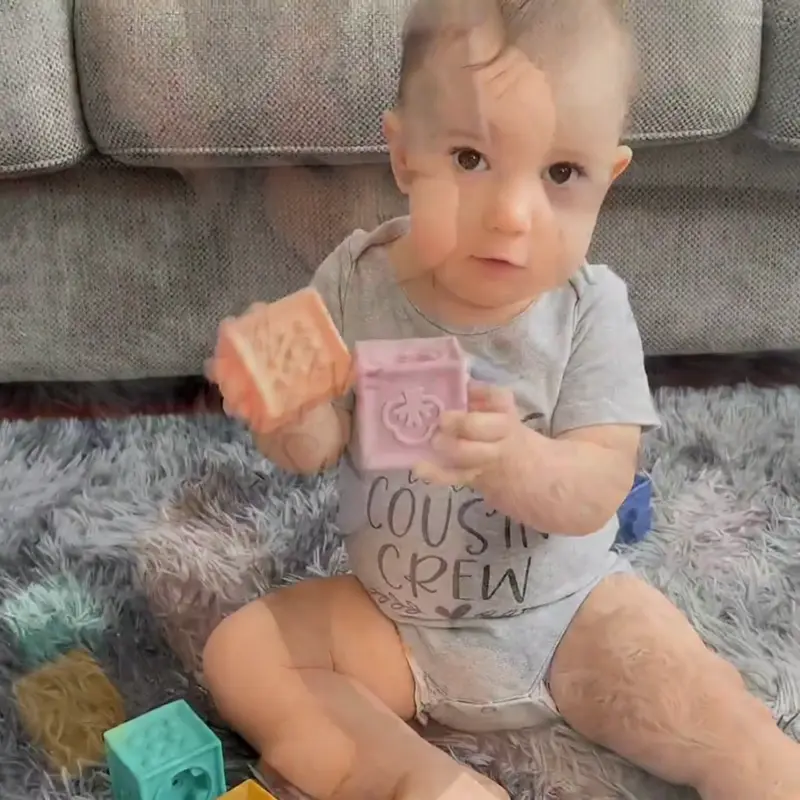 babies playing with silicone stacker rings and blocks