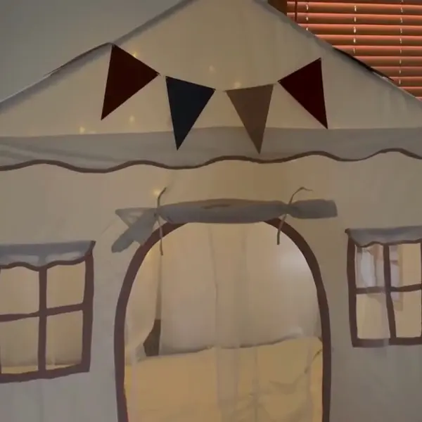 two kids a girl and boy playing in a app-up play tent or playhouse for toddlers